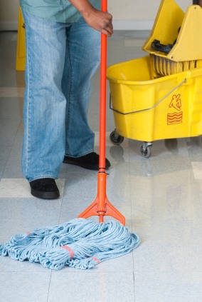 Denver Janitorial Company janitor in Edgewater, CO mopping floor.